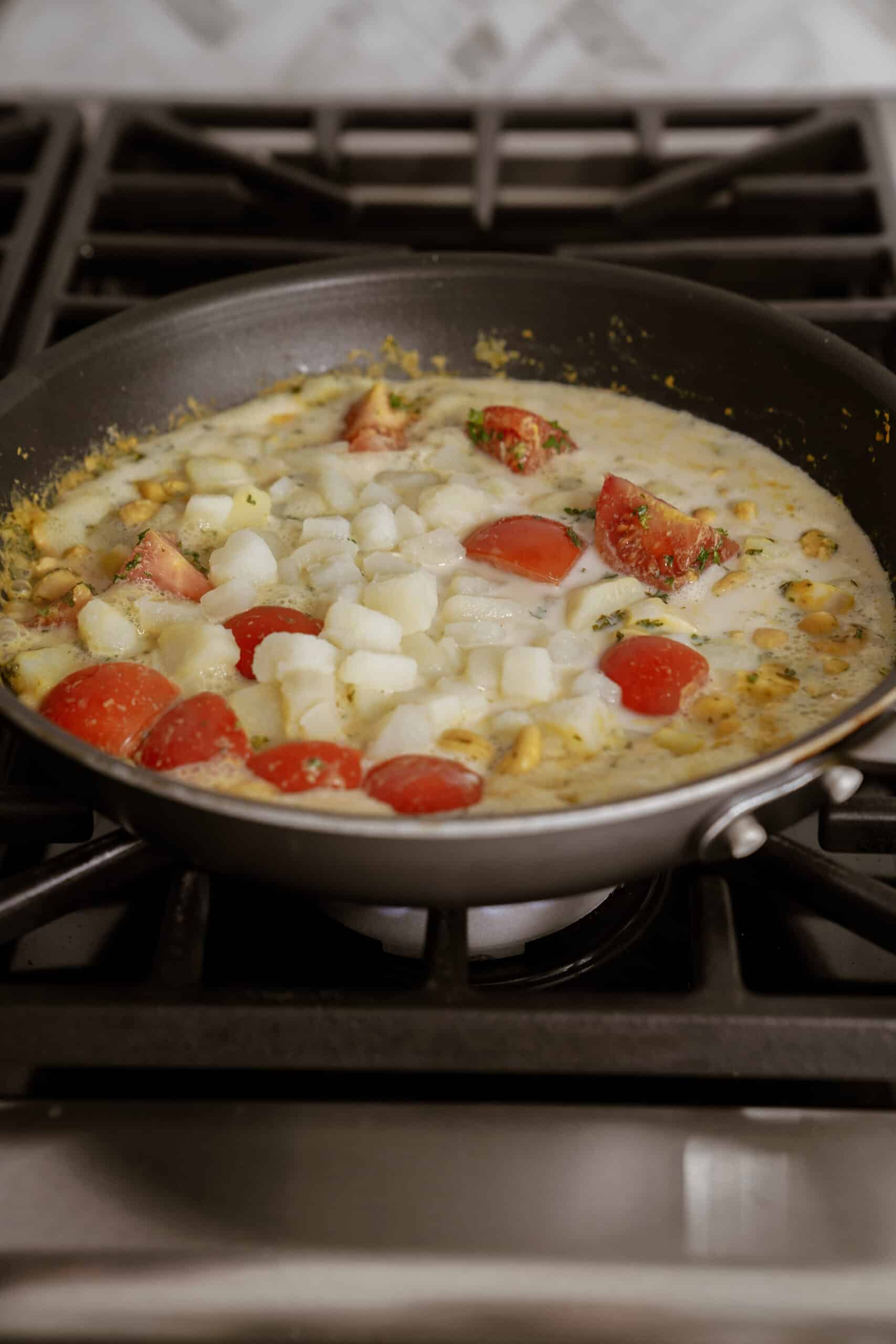 Ingredients for spaghettini in pan simmering