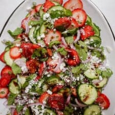 Strawberry cucumber salad on a large serving dish