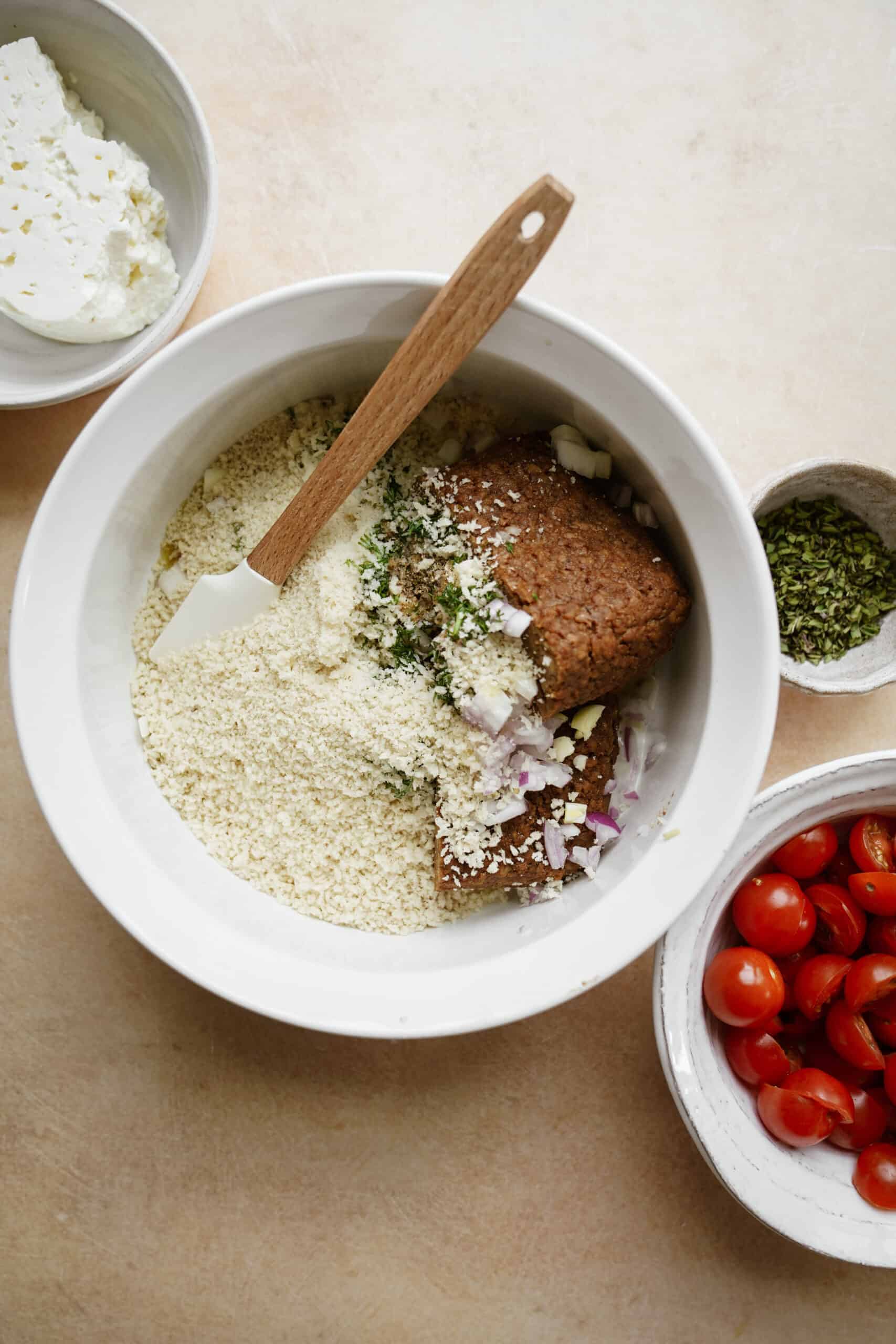 Ingredients for vegan meatballs in bowl being mixed