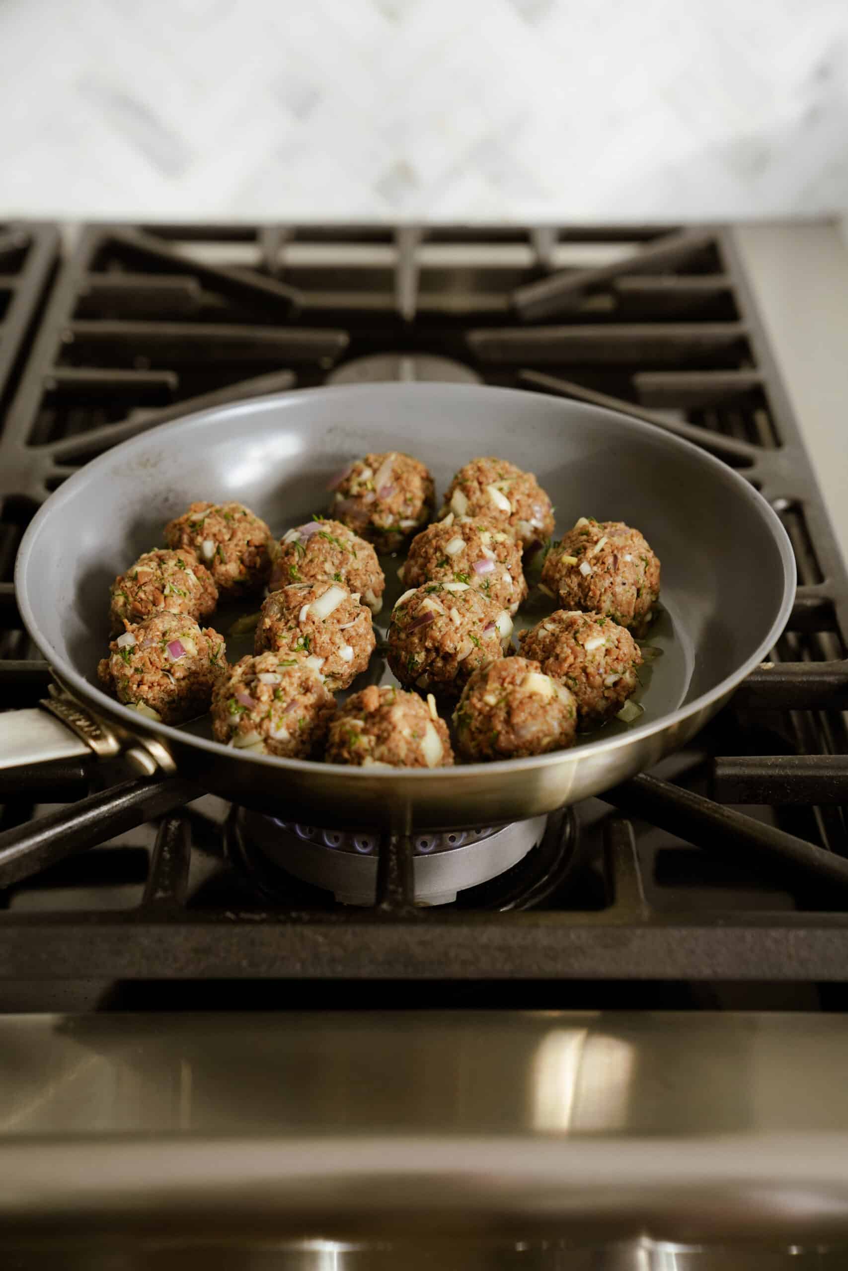 Cooking vegan Greek meatballs in a pan 