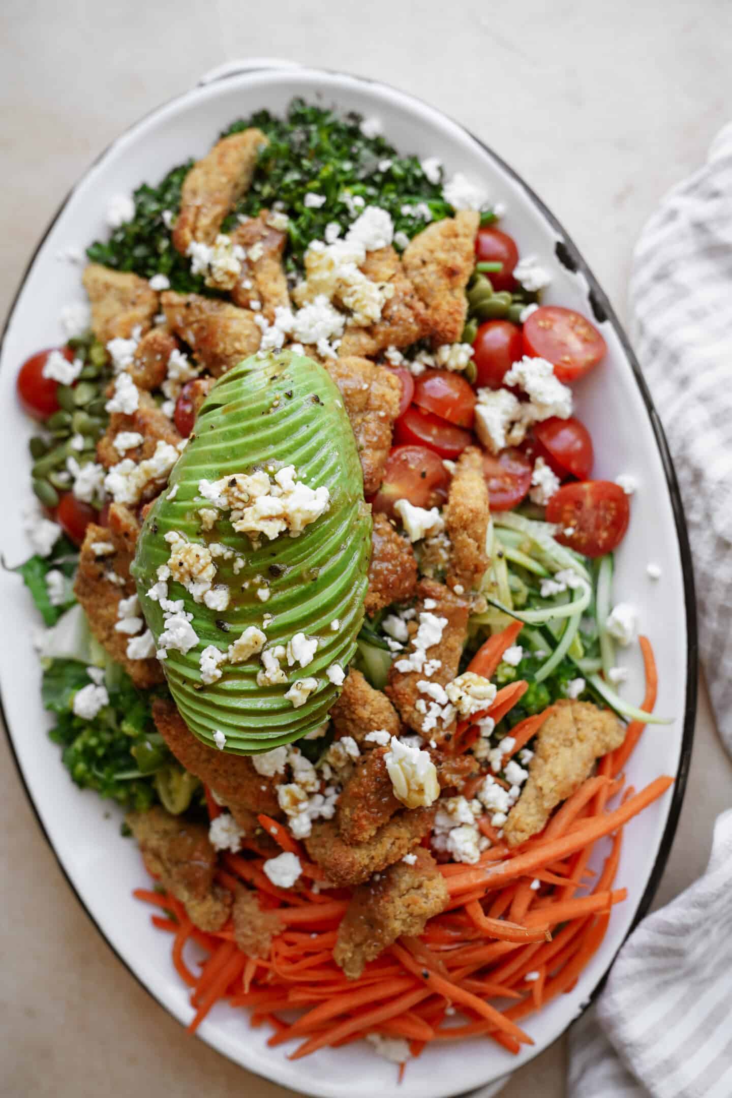 Chopped salad in a big white serving dish 