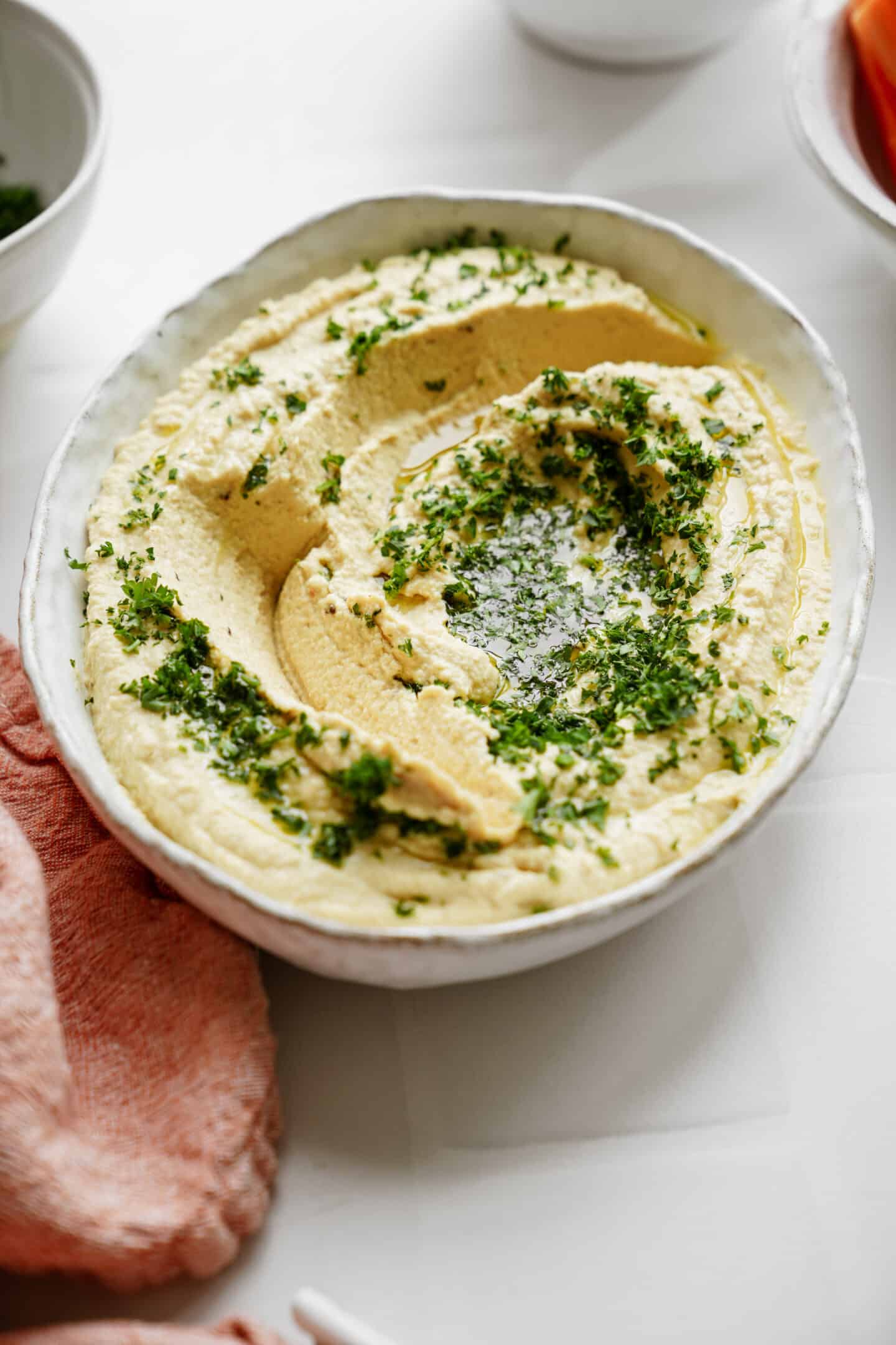 Homemade hummus in a white bowl