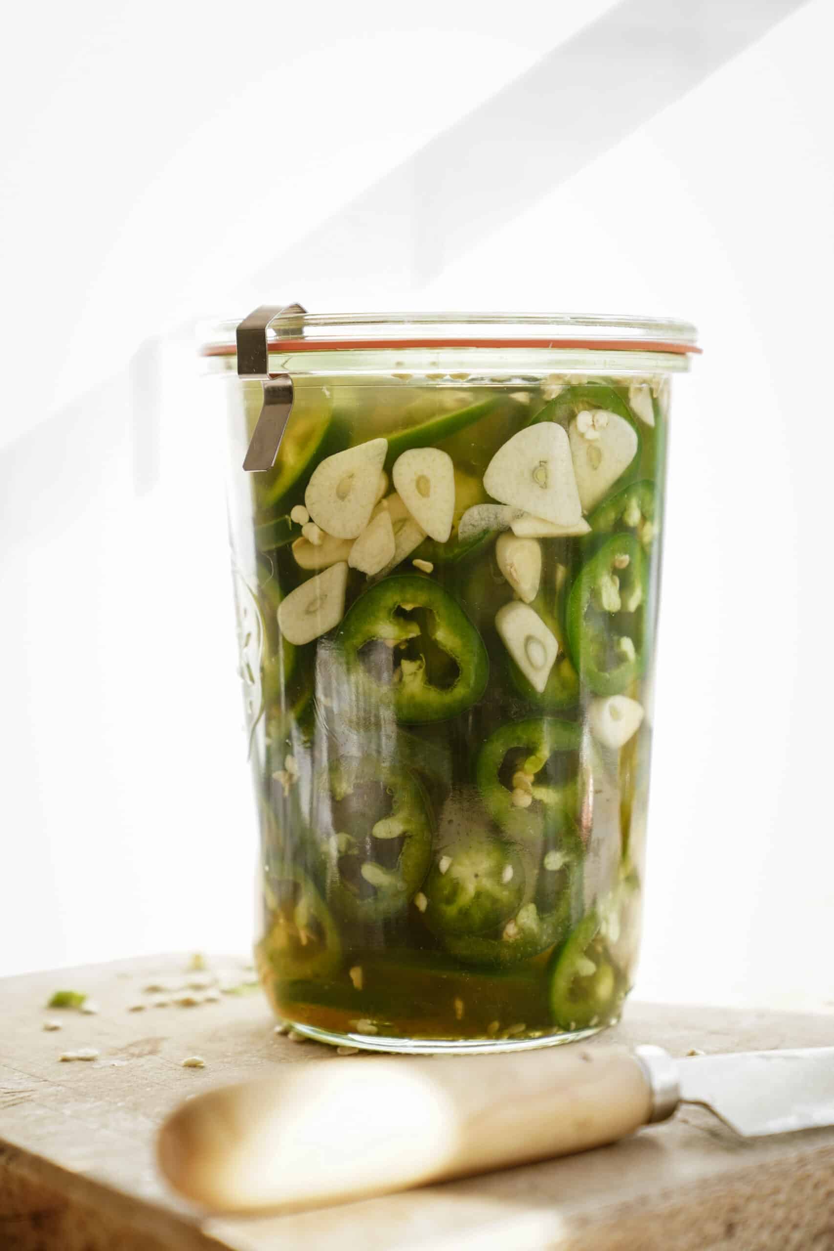 Jar of pickled jalapenos with garlic