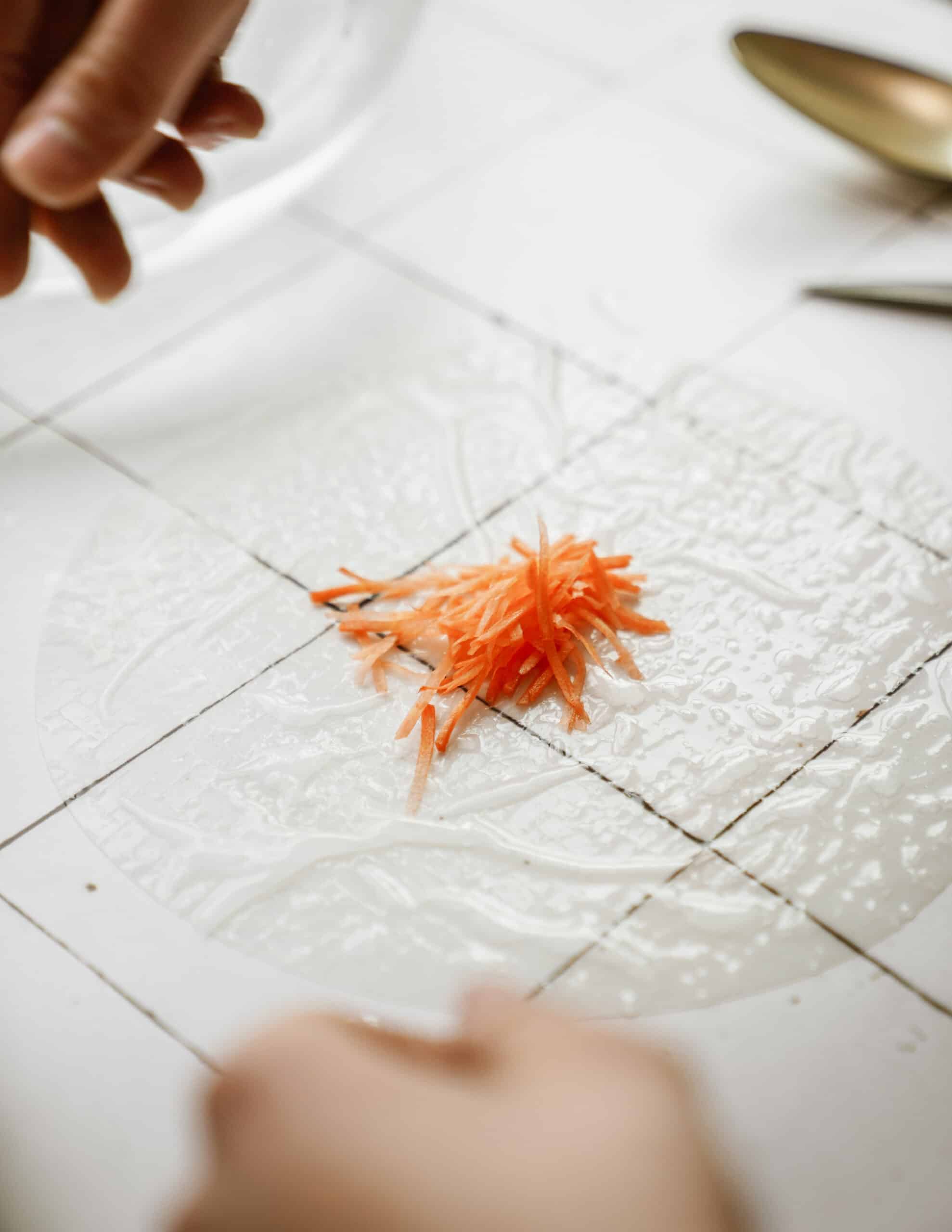 Shredded carrot on wet rice paper