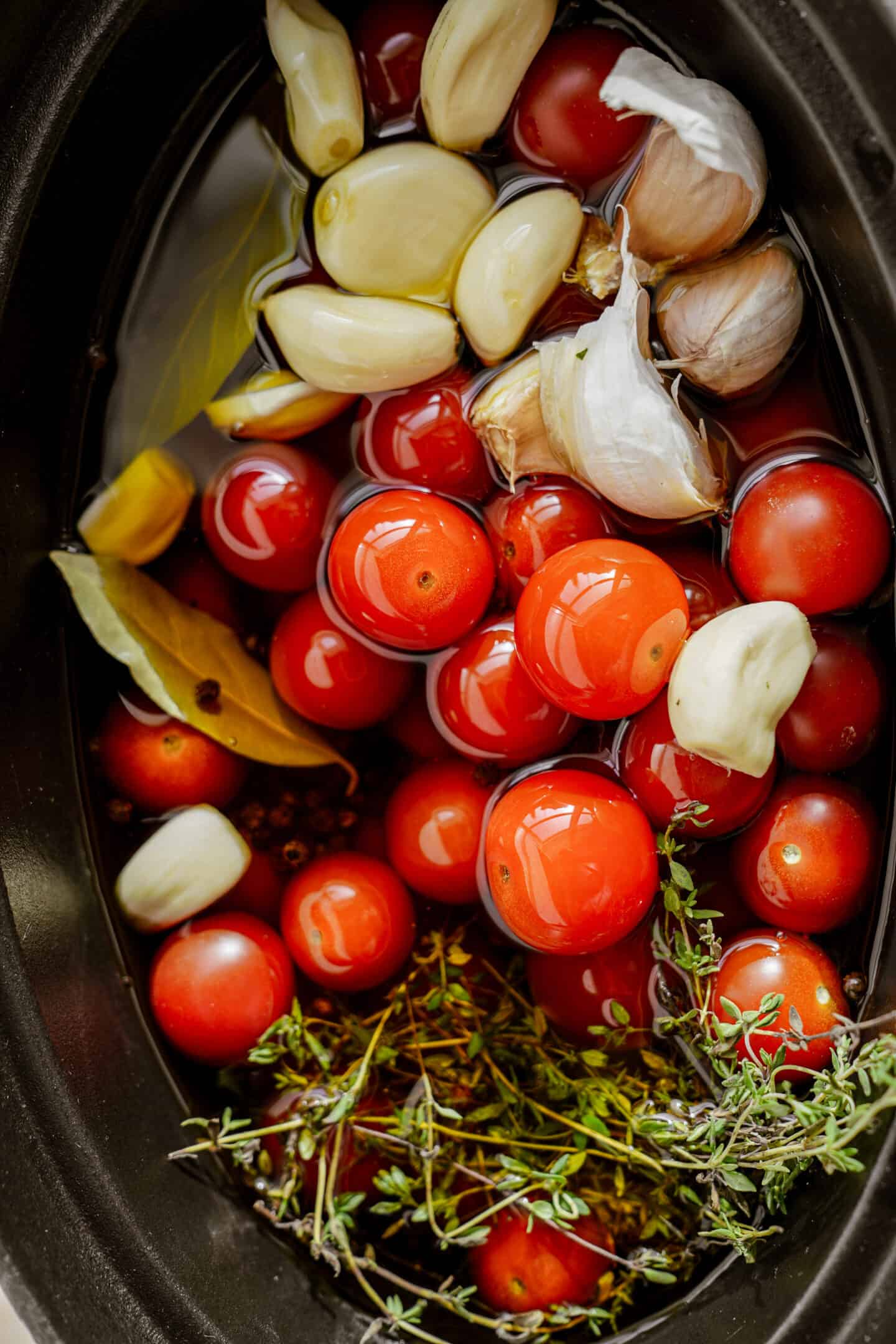 Ingredients for tomato confit in a pot