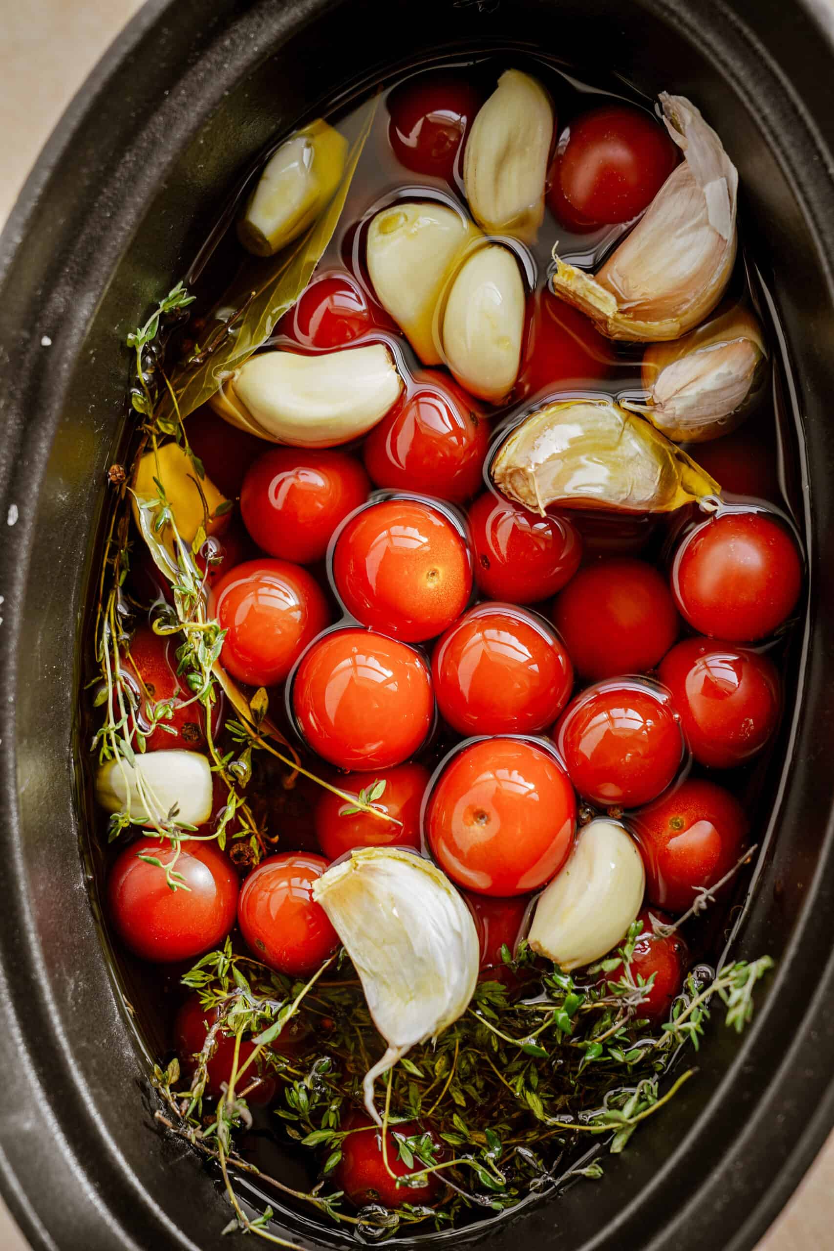 pot with tomato, garlic, thyme
