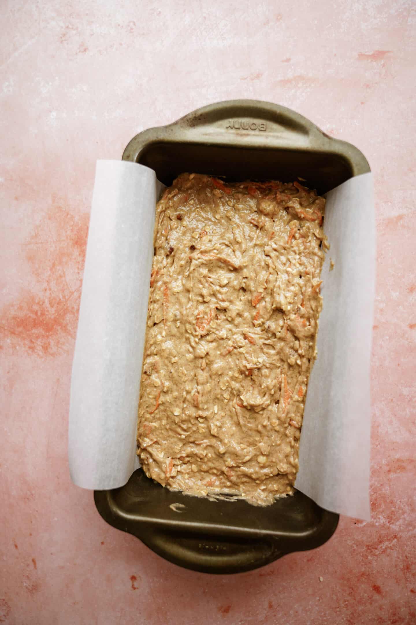 Batter for carrot cake banana bread laid in a pan