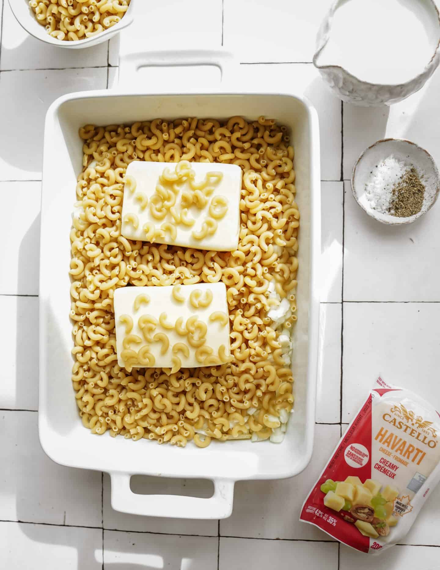 Ingredients for one pot mac and cheese in a casserole dish