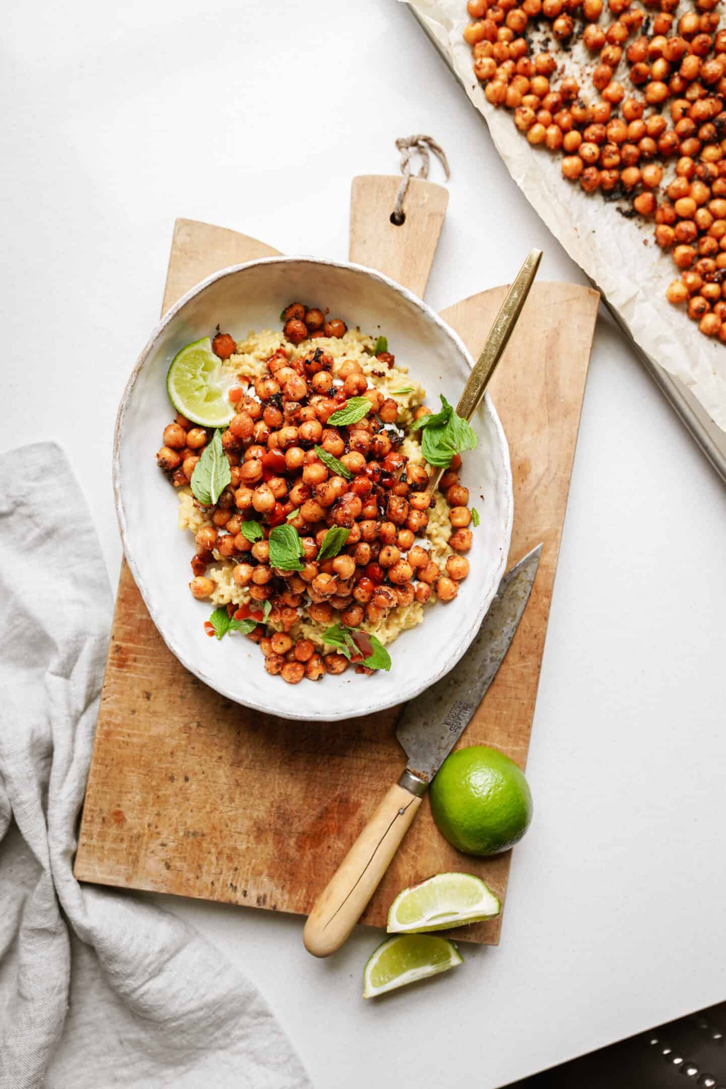 Crispy chickpeas on a serving dish on a cutting board