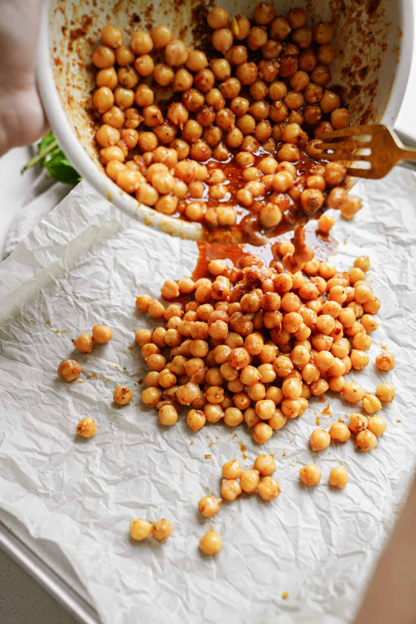 Chickpeas being poured on a baking tray