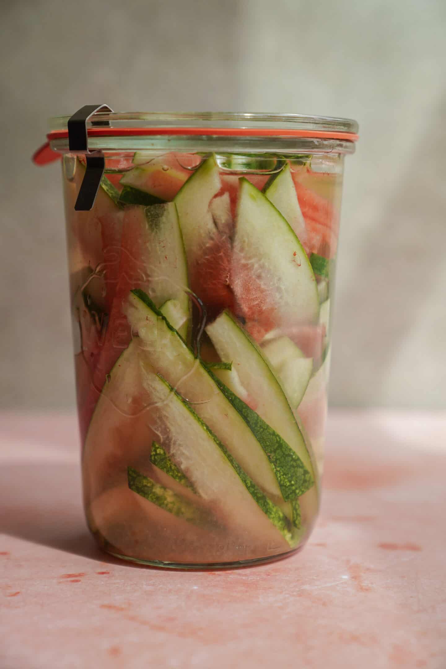 Close-up of pickled watermelon rind in a jar