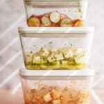 Tofu marinating in containers with veggies