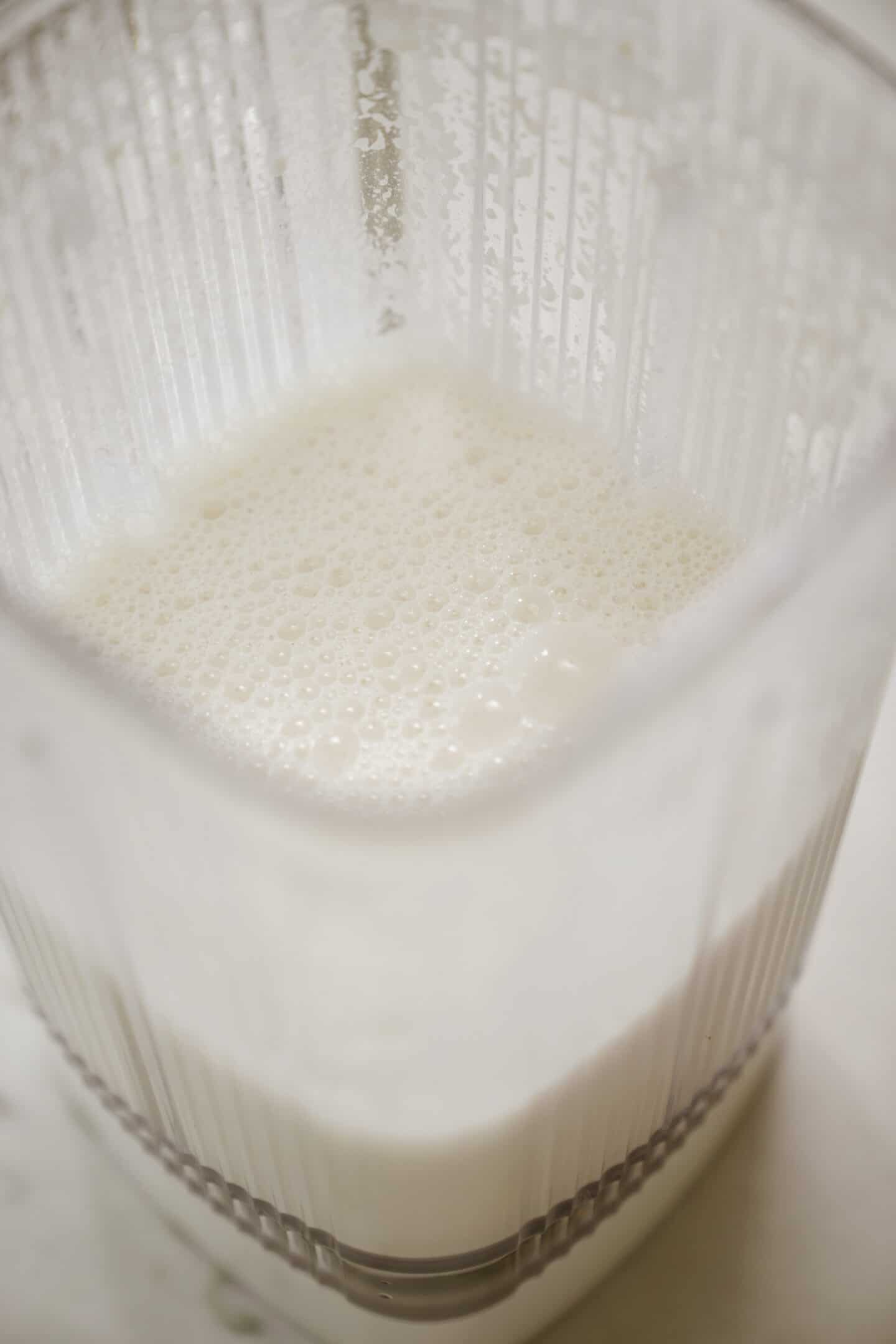 Close-up of barista oat milk in a blender