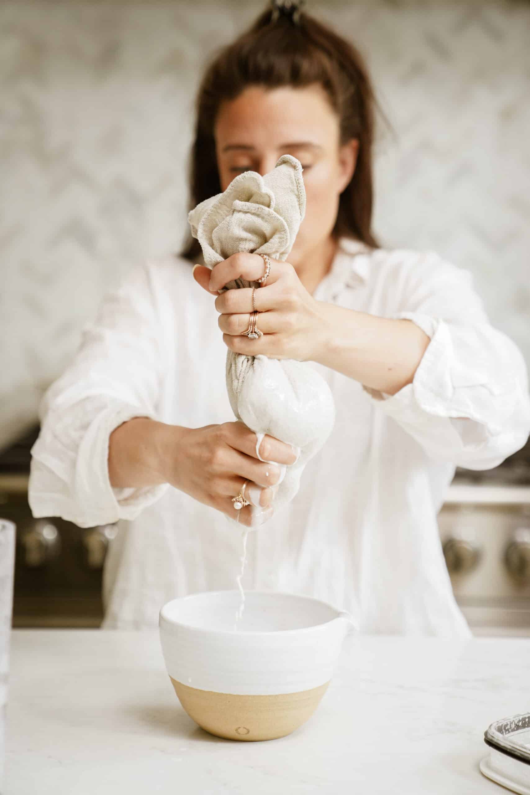 Maria making barista oat milk in a bowl