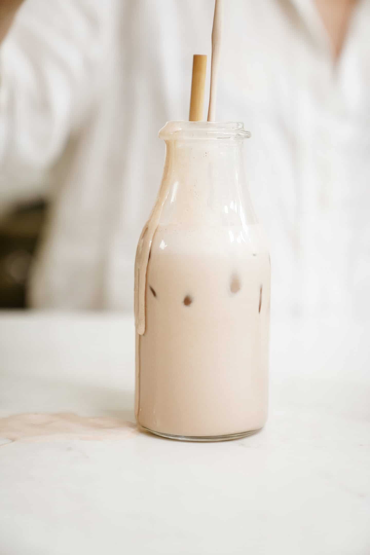 Barista oat milk in a jug on a countertop.