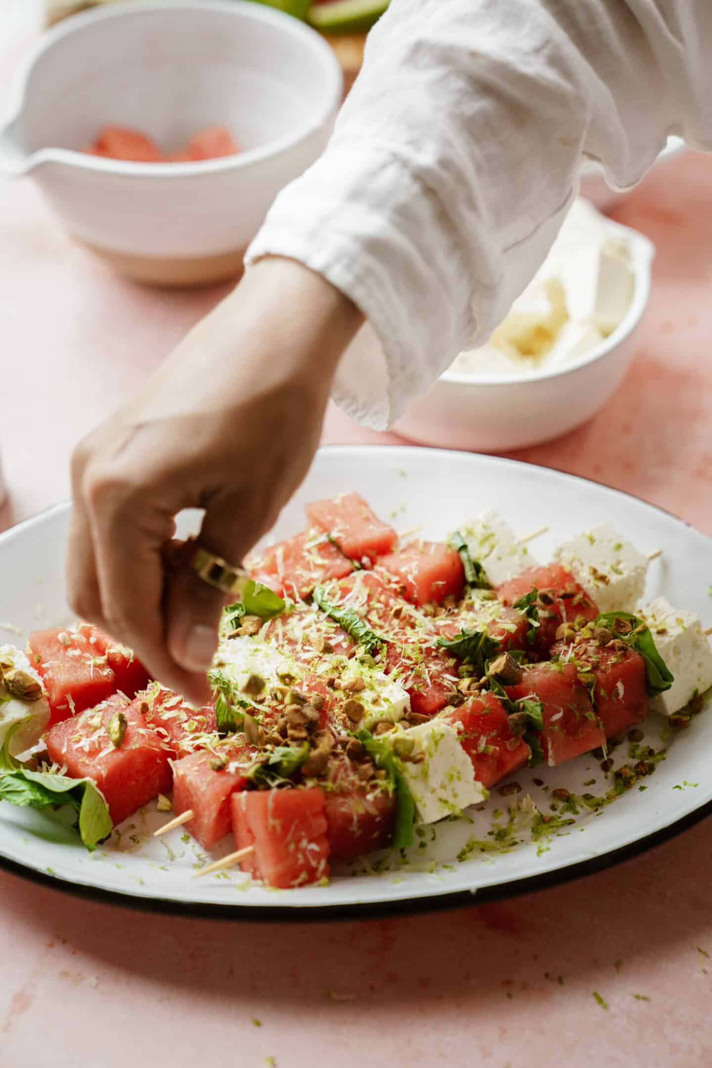 Adding toppings to one of Maria's fav summer appetizers