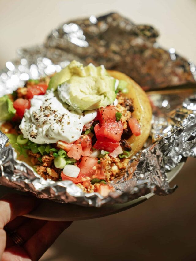 Close-up of a loaded baked potato in tin foil