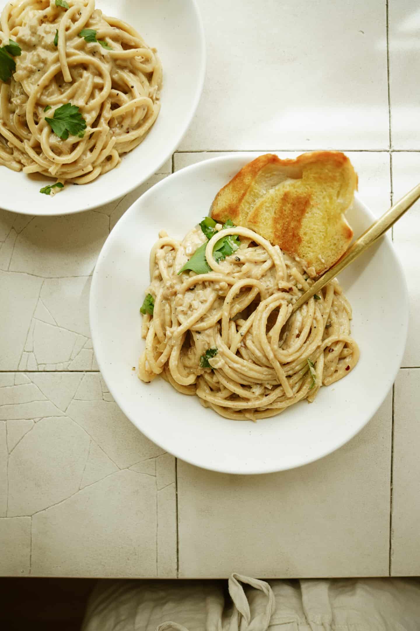 Bowl of fettuccine alfredo with garlic bread