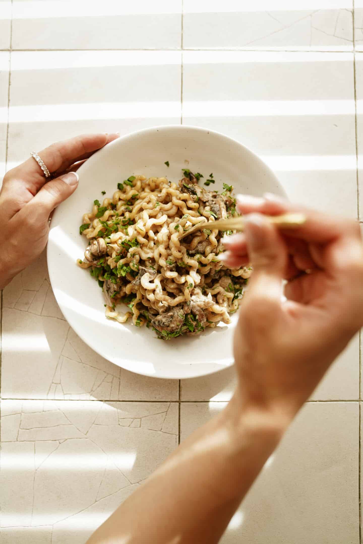 Mushroom sauce in a white bowl on pasta