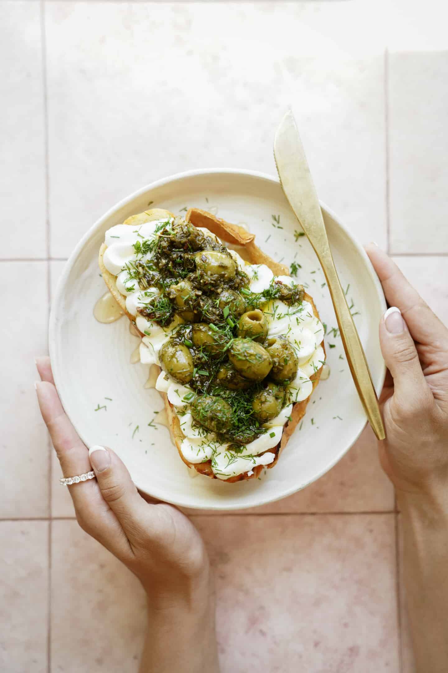 Whipped ricotta toast with olives on top
