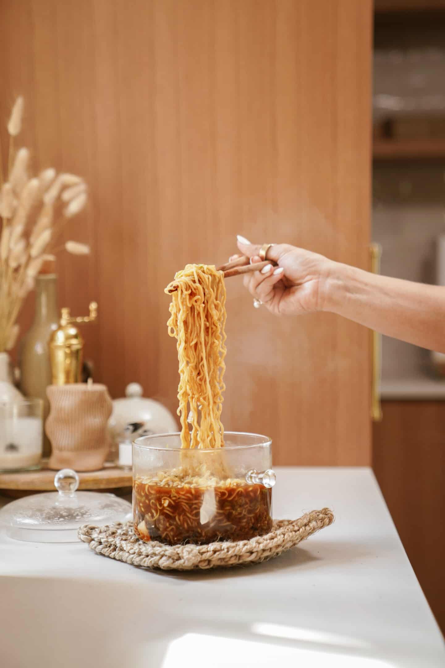 A spoon scooping out ramen from a bowl