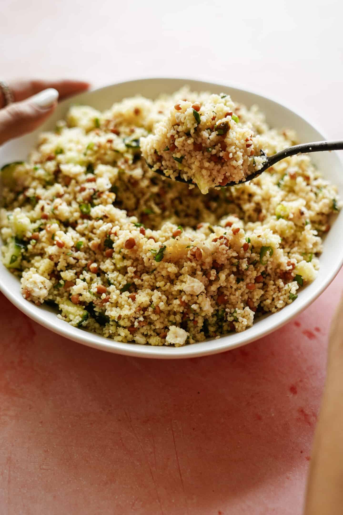 Close up of spoon scooping couscous recipe