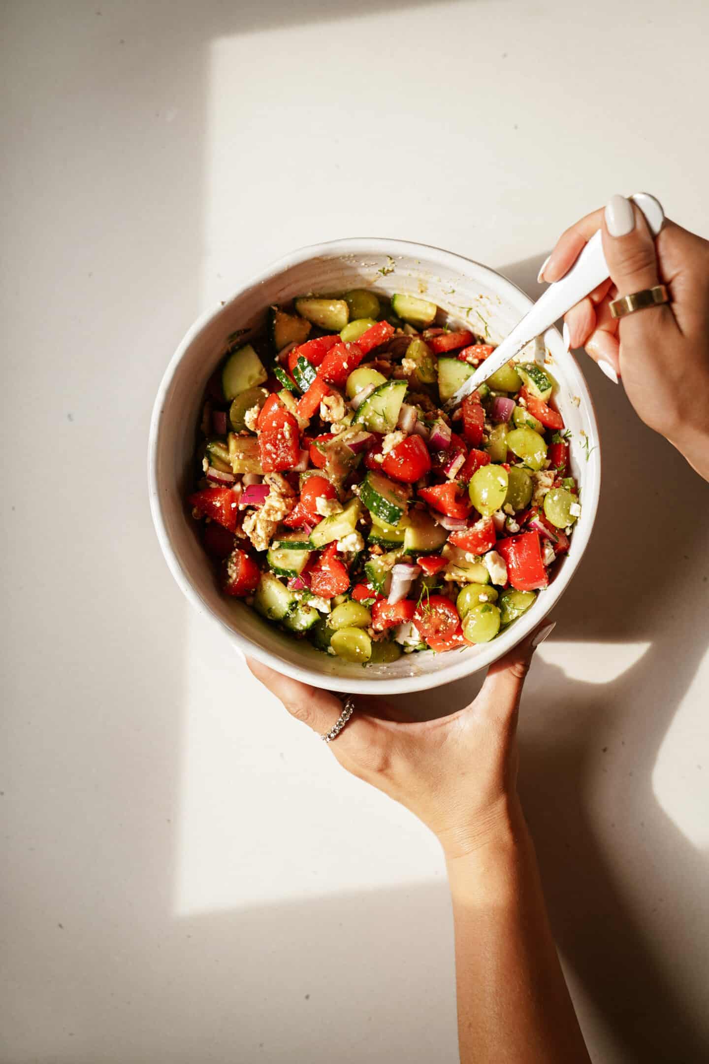 Bowl of grape salad with a spoon in it