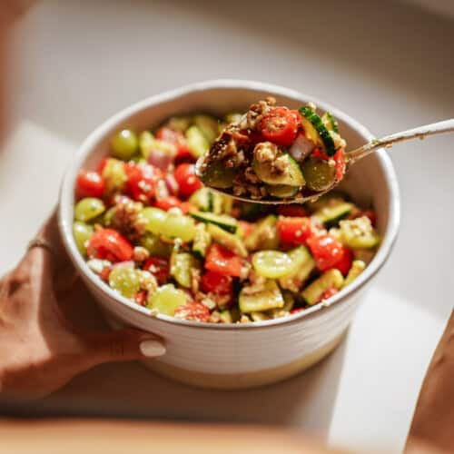 Spoon scooping out a spoonful of grape salad