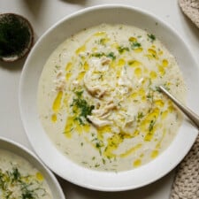 Avgolemono soup in a white bowl