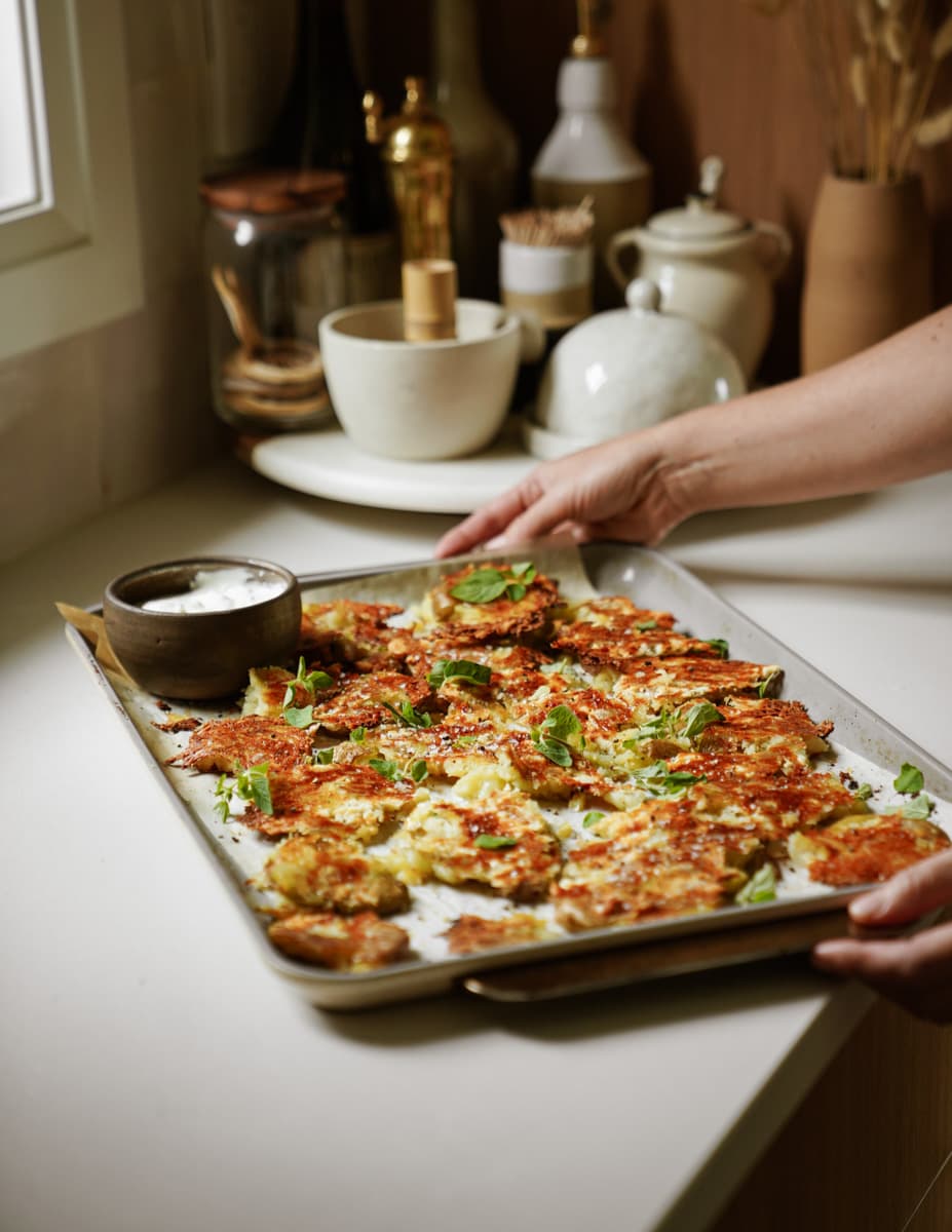 Baking tray with crispy potatoes on it