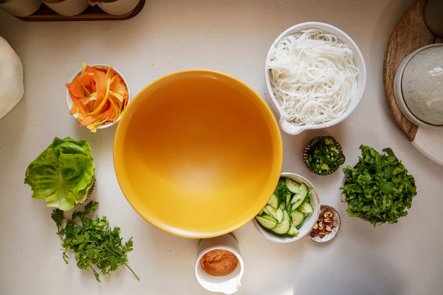 Ingredients around a big bowl for a vermicelli bowl
