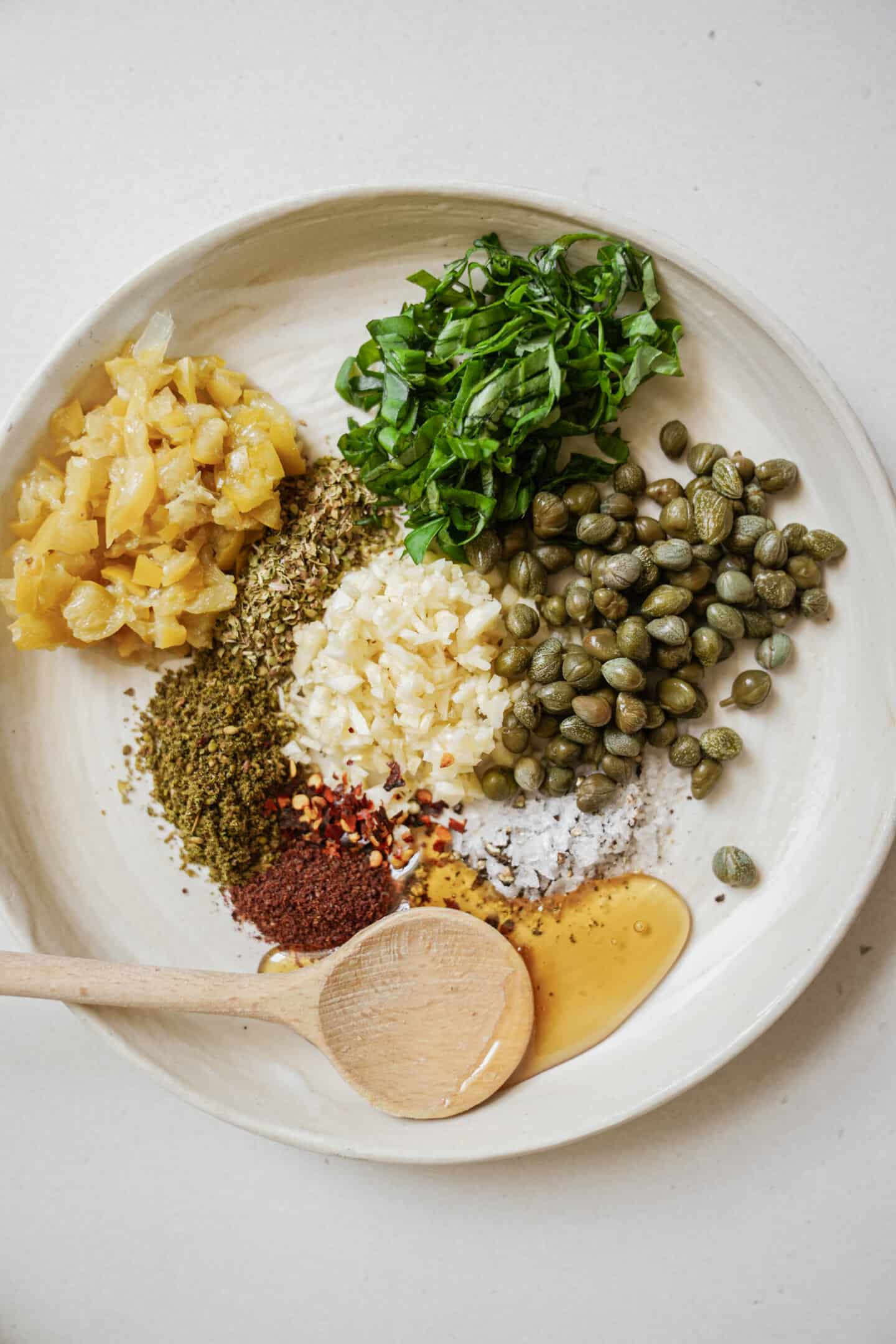 Ingredients laid out on a plate for bread dipping oil
