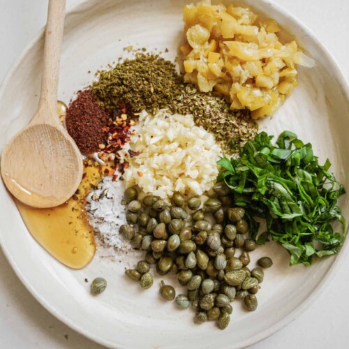 Ingredients laid out on a plate for bread dipping oil