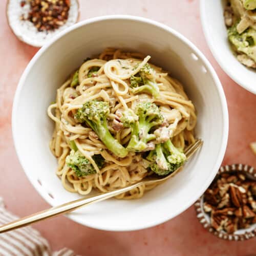 White bowl of creamy broccoli pasta