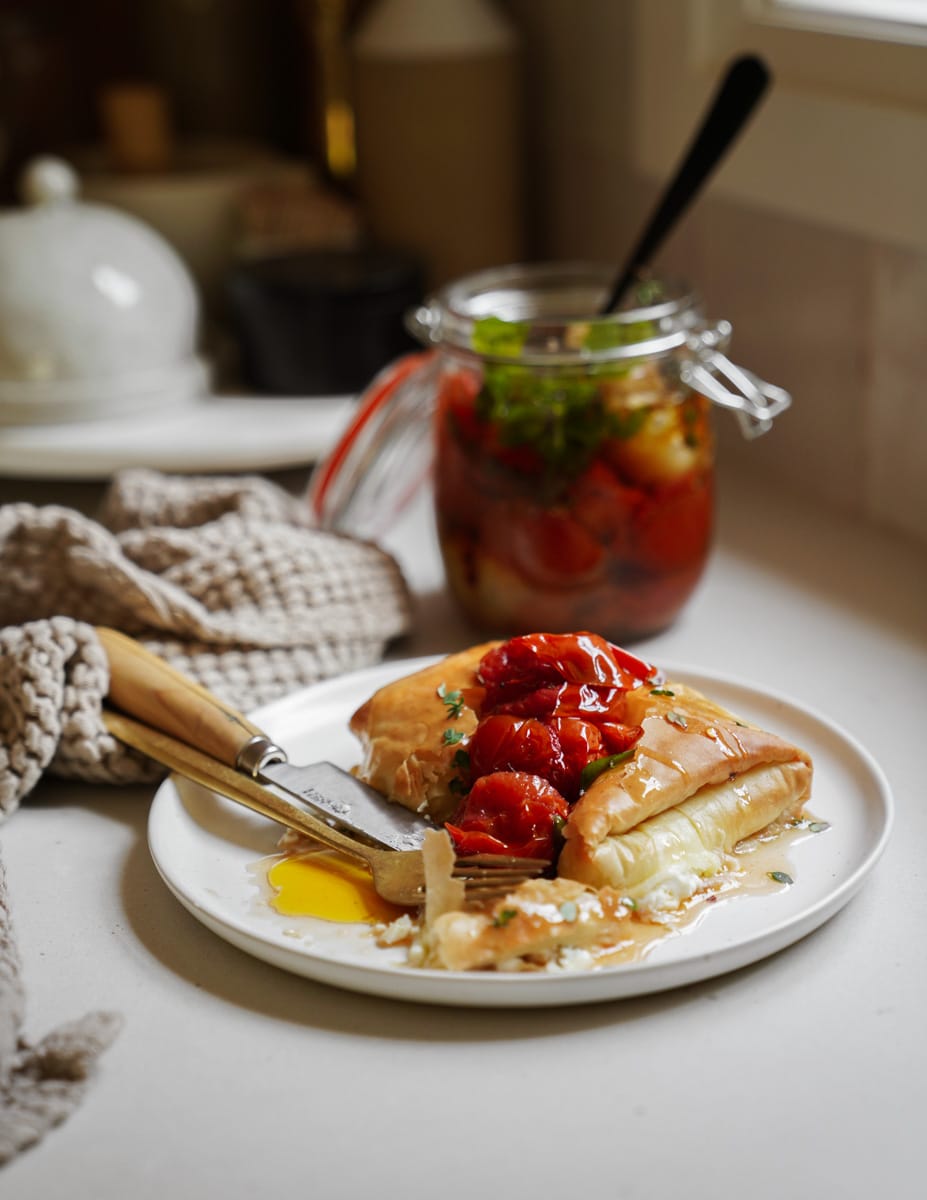 Tiropita on a plate with tomatoes