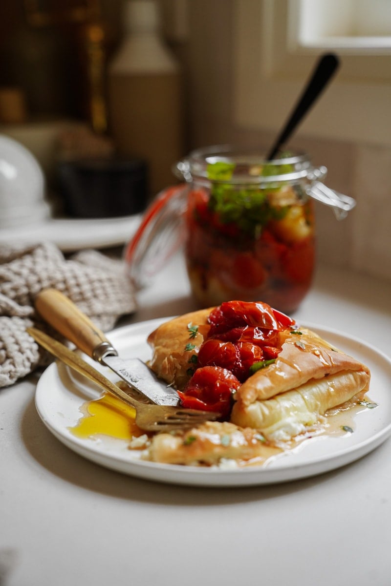 Tiropita on a plate with tomatoes