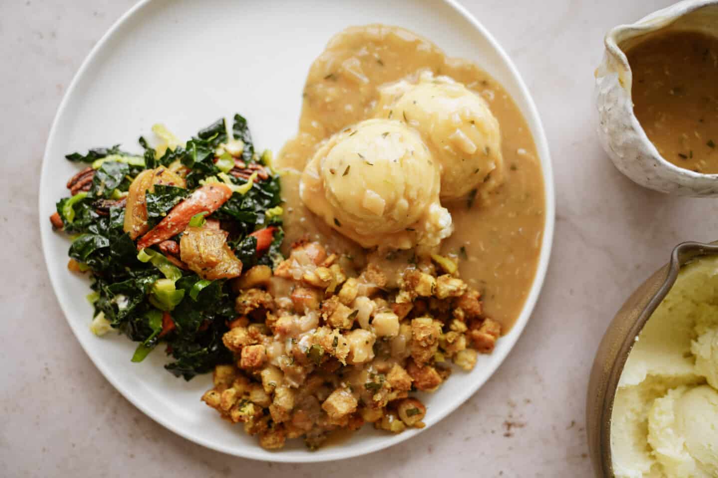 Plate of holiday food with a stuffing recipe on the side