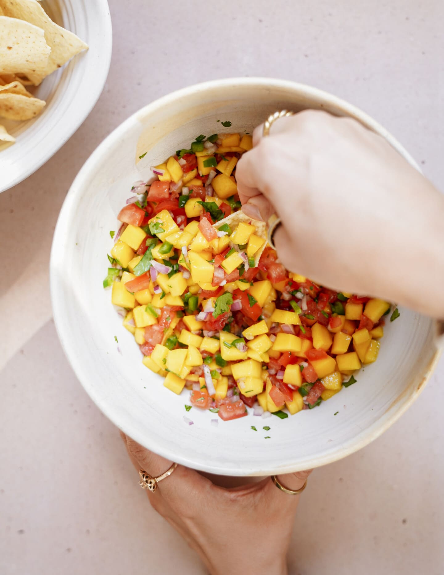 Mixing mango salsa in a bowl
