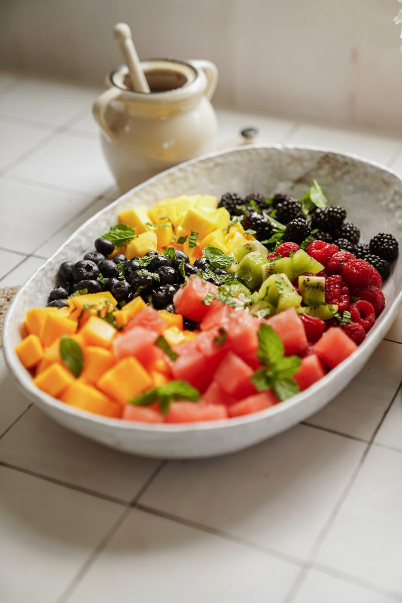 fresh fruit salad in a white serving dish