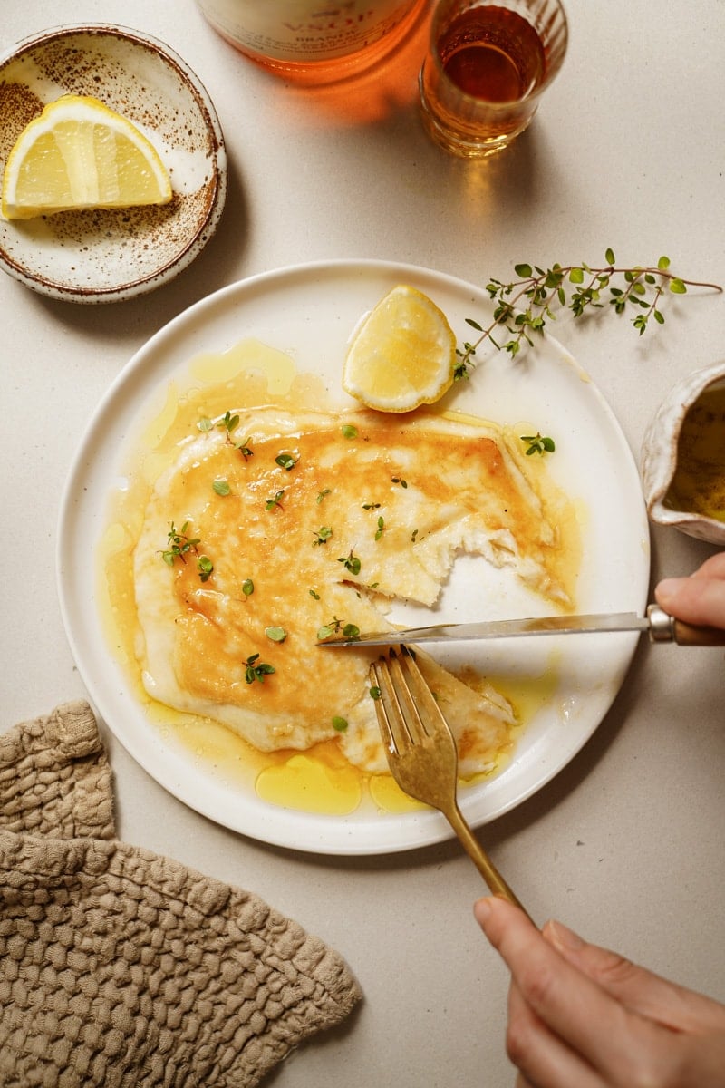 Saganaki on a serving dish with a fork and knife cutting it