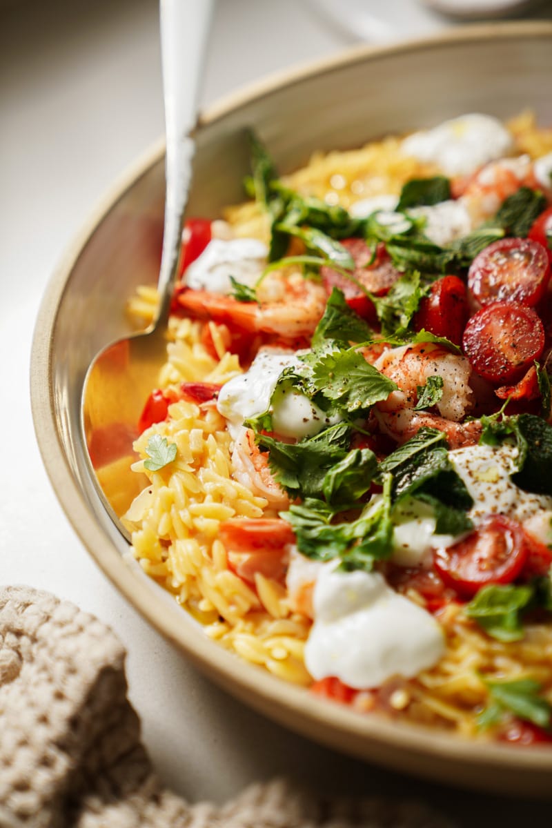 One pot orzo close up with a spoon in it