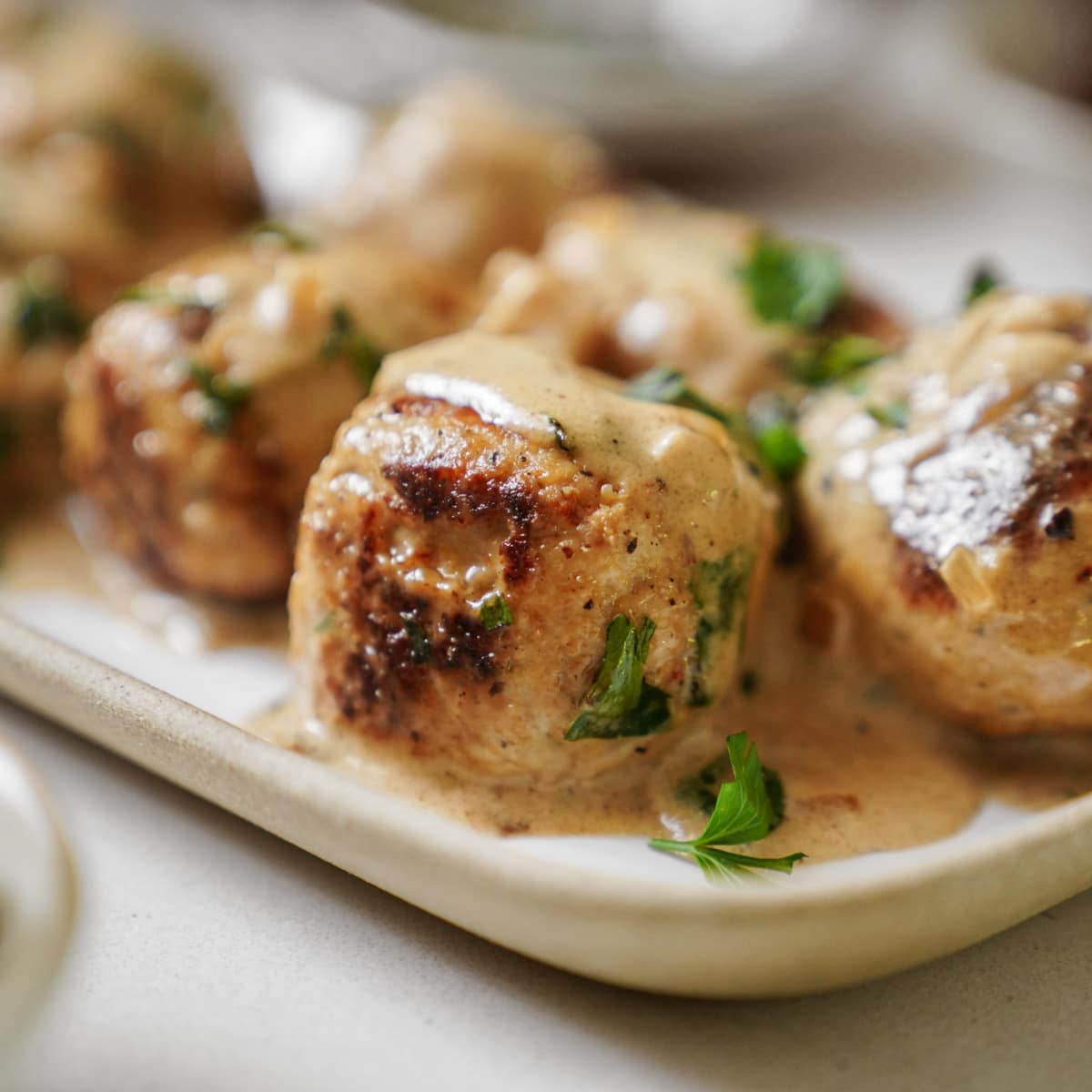 Close up of butter lemon sauce on chicken meatballs