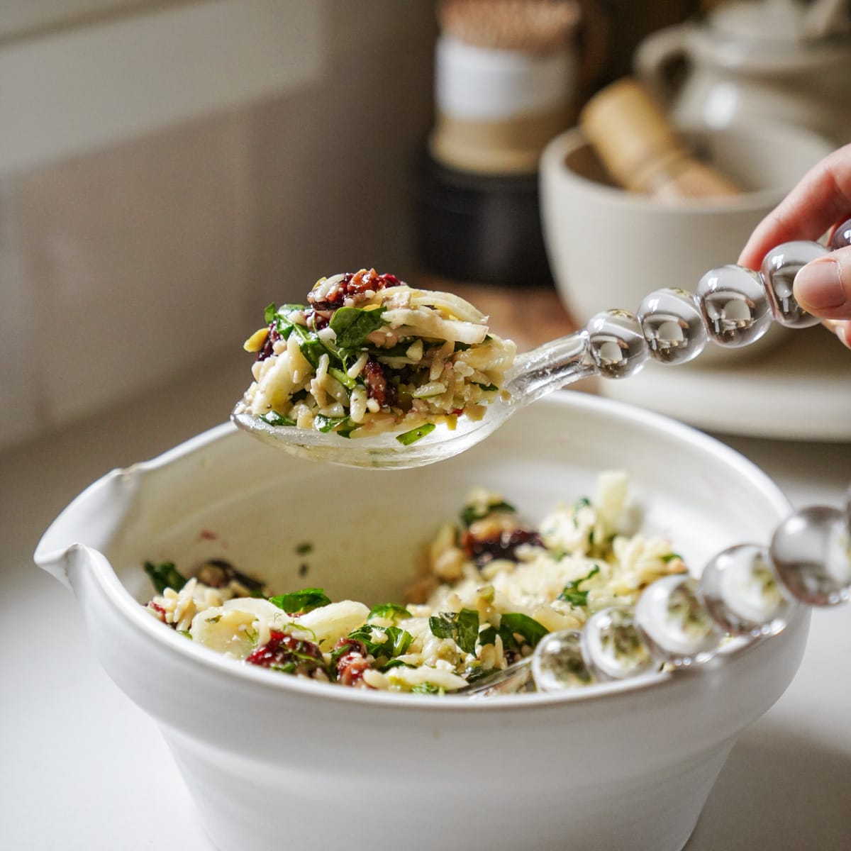 Christmas salad ingredients mixed into a salad bowl