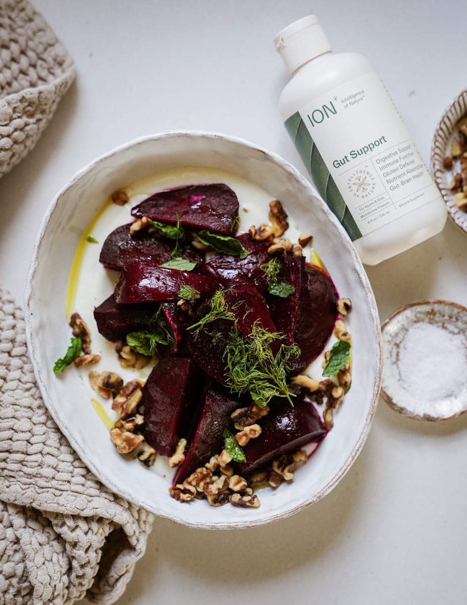 Roasted beet salad in a serving dish with ION Gut Support next to it