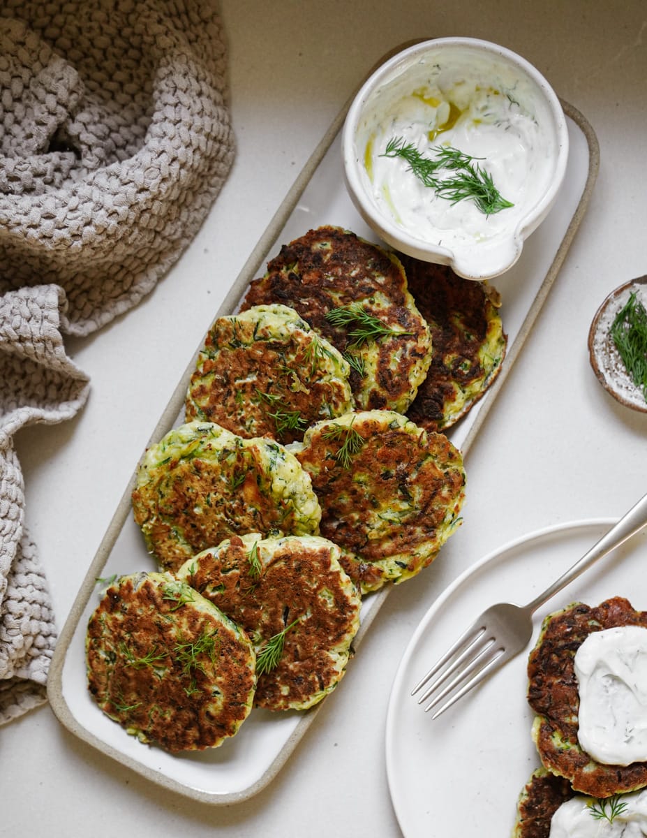 Close up of zucchini fritters on a serving dish
