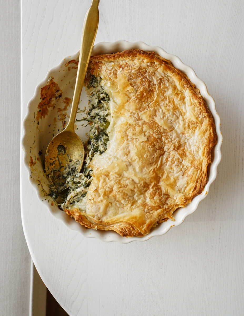 Spinach pie with a serving spoon in it