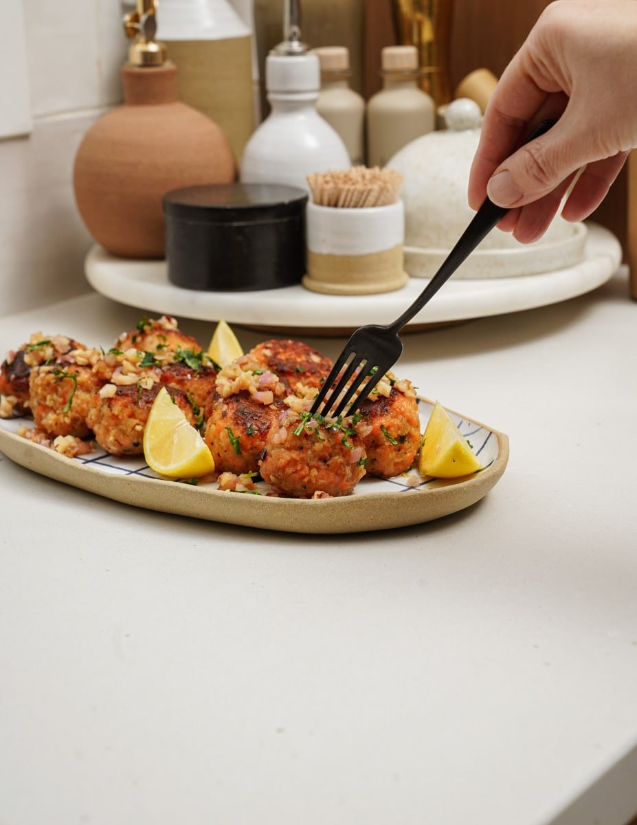 Fork taking salmon ball off a plate