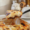Moussaka being pulled out of a baking dish