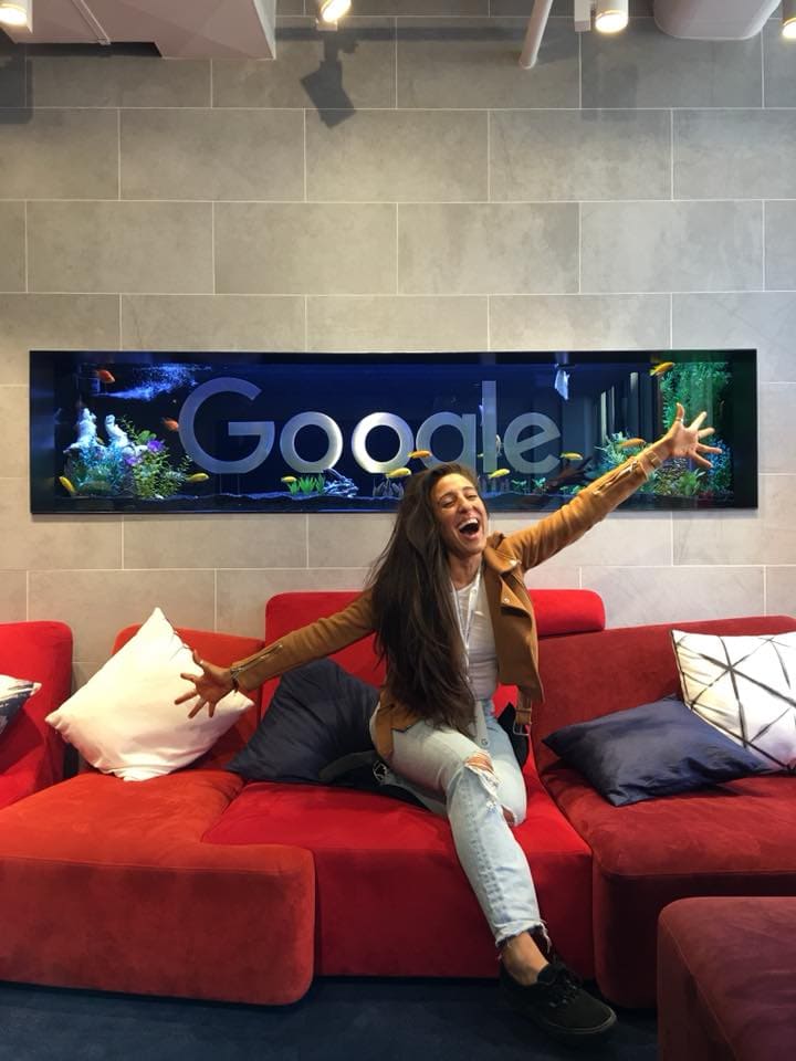 Maria sitting in front of google sign