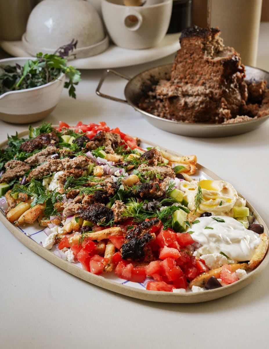 Gyro meat on a platter with vegetables